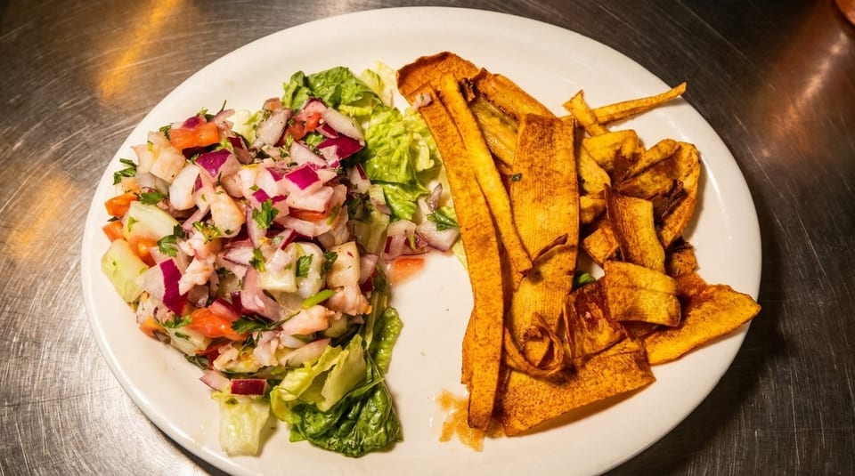 Shrimp ceviche with red onions, tomatoes, and cilantro, served with crispy plantain chips.